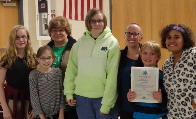 Super Sewing Sisters 4-H Textile Science Club receives their official 4-H club charter from National 4-H Headquarters, United States Department of Agriculture. Pictured from left are: Lily Roberti; Carolyn Roberti; Pat Zeeman, 4-H leader; Anna Gordon; Victoria Staples, 4-H leader; Micah Staples; and Hazel Staples. [Photo provided]