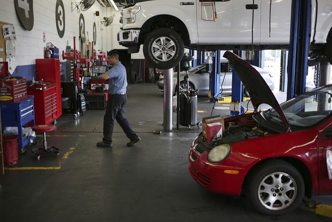 Cars await service at a Pep Boys — Manny Moe & Jack service center in Clarksville, Indiana. [Bloomberg / Luke Sharrett]
