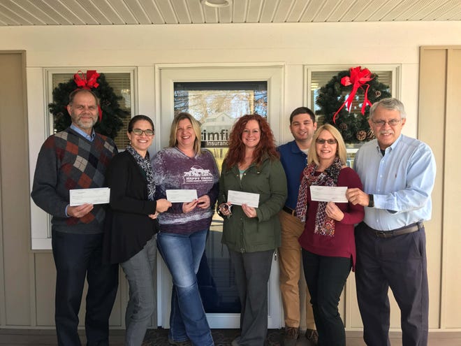 Receiving their grant checks are, from left, Dana Downing of Mobile Meals, Erin Madonio Latina of MFAWT, Laurie Jackson of Happy Trails, Chalan Lowry of the Portage APL, Andrew Madonio of MFAWT, Pat Bailey, of Rose’s Rescue and Chas Madonio of MFAWT. Submitted photo