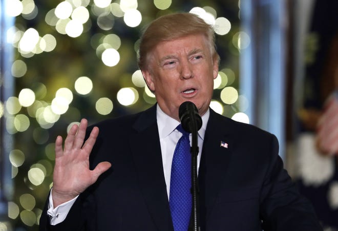 In this Dec. 13, 2017, photo, President Donald Trump speaks in the Grand Foyer of the White House in Washington. Most Americans think Trump did something either Illegal or unethical regarding his presidential campaign's ties to Russia_ and they think heþÄôs trying to obstruct the investigation looking into those connections. A new poll by the Associated Press-NORC Center for Public Affairs Research reveals a deeply divided country more concerned about health care and the economy than any collusion with the Kremlin (AP Photo/Evan Vucci)