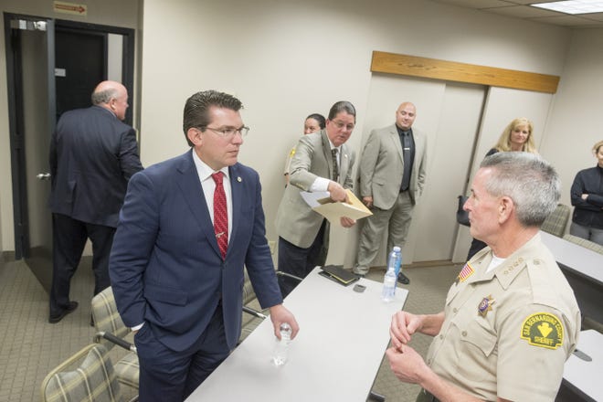 State Assemblyman Jay Olbernotle, center, speaks with San Bernardino County Sheriff John McMahon after a crime and public safety forum at the Daily Press in Victorville on Friday. [James Quigg, Daily Press]