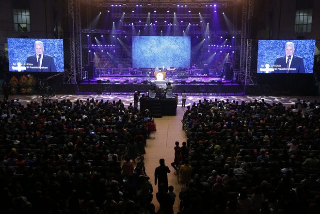 Evangelical preacher Franklin Graham speaks Dec. 8 in front of an audience in Hanoi, Vietnam. More than 10,000 Vietnamese filled up a stadium in a rare Christian evangelistic event led by Graham, who says he wants the communist government to consider Christians its best citizens. [AP Photo/Tran Van Minh]