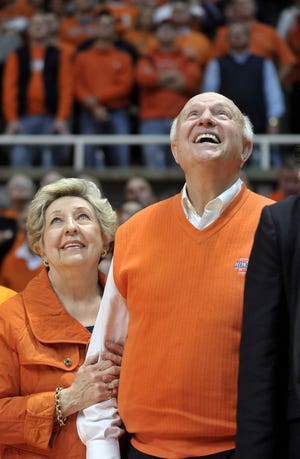 Former Illinois coach Lou Henson, with his wife, Mary Henson, watches a video presentation showcasing his history with Illinois men's basketball, before his coaching banner was displayed at halftime of an NCAA college basketball game between Ohio State and Illinois in Champaign, Ill., on Tuesday, Jan. 10, 2012. (AP Photo/Heather Coit)