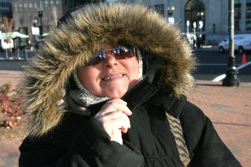 The weather Saturday will be almost as cold as this December day in 2009, when Sherry Vanni, of Providence, was waiting for a bus in Kennedy Plaza. [The Providence Journal, file / Kathy Borchers