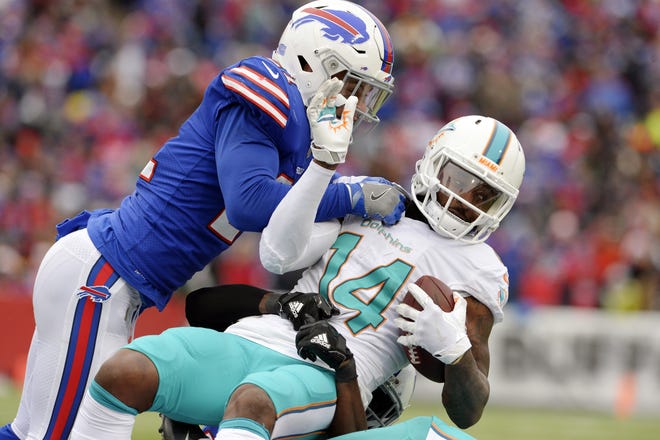 Buffalo Bills' Jordan Poyer, left, tackles Miami Dolphins' Jarvis Landry, right, during the first half of an NFL football game Sunday, Dec. 17, 2017, in Orchard Park, N.Y. (AP Photo/Adrian Kraus)