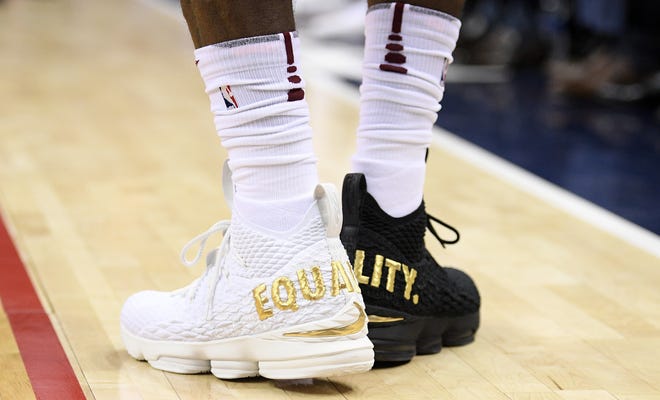 Cleveland Cavaliers forward LeBron James' shoes are emblazoned with "EQUALITY" on both heels during the first half of an NBA basketball game against the Washington Wizards, Sunday, Dec. 17, 2017, in Washington. (AP Photo/Nick Wass)