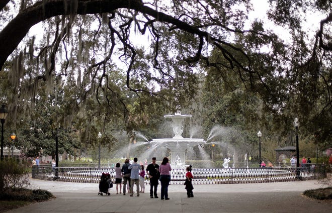 FILE - In this Feb. 21, 2011 file photo, people gather at the Forsythe Park fountain in the historic district of Savannah, Ga. Lured by the city's time-capsule collection of antebellum homes and manicured public squares, tourists spent an estimated $2.8 billion here in 2016. (AP Photo/David Goldman, File)