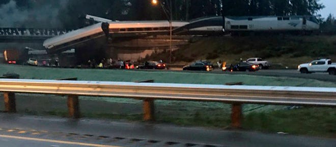 This photo provided by Danae Orlob shows an Amtrak train that derailed south of Seattle on Monday, Dec. 18, 2017. Authorities reported “injuries and casualties.” The train derailed about 40 miles (64 kilometers) south of Seattle before 8 a.m., spilling at least one train car on to busy Interstate 5. (Danae Orlob via AP)
