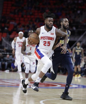 Detroit Pistons forward Reggie Bullock (25) brings the ball up court during the first half of an NBA basketball game against the Denver Nuggets, Tuesday, Dec. 12, 2017, in Detroit. (AP Photo/Carlos Osorio)