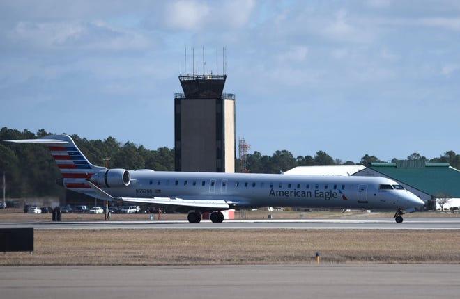 An American Eagle flight taxis by the control tower after landing at Wilmington International Airport in February. American plans to its service at the airport to include nonstop daily service to Washington and seasonal summer service to Chicago. [STARNEWS FILE PHOTO]