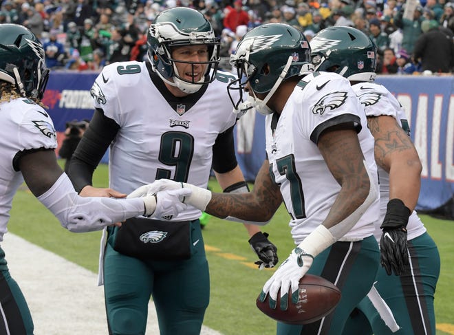 Philadelphia Eagles quarterback Nick Foles (9) celebrates with wide receiver Alshon Jeffery (17) after they connected on a touchdown pass against the New York Giants on Sunday. [AP Photo/Bill Kostroun]
