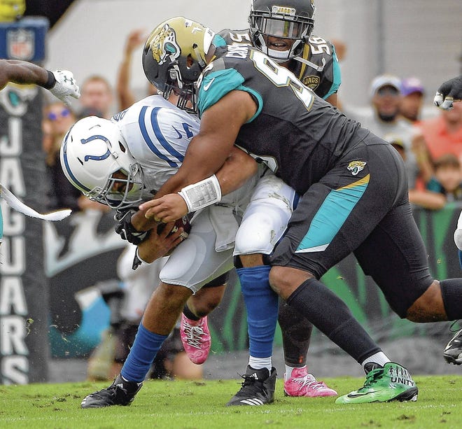 Jaguars defensive end Calais Campbell sacks Indianapolis Colts quarterback Jacoby Brissett earlier this month. Campbell’s 14 1/2 sacks are second in the NFL. (AP Photo/Phelan M. Ebenhack)