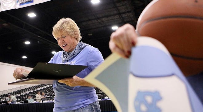 North Carolina women's basketball coach Sylvia Hatchell looks over a proclamation she was presented after Tuesday's game.