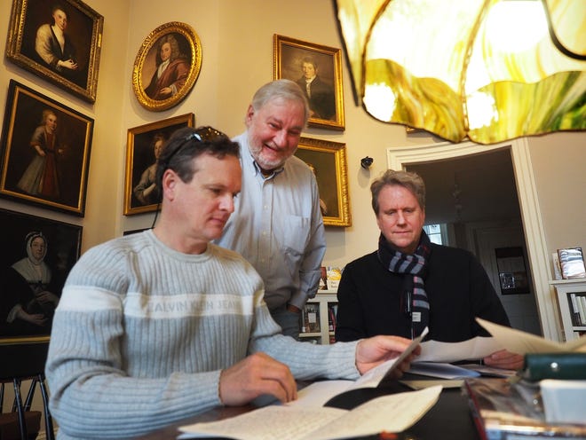 From left, judges Stephen Fee, Gregg Schroeder and Michael Sky Danley look over several creative proposals for reusing remnants of the circa 1758 Olde State House that was once located in Market Square, Tuesday at the Portsmouth Athenaeum. [Rich Beauchesne/Seacoastonline]