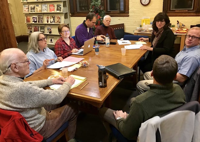 The Rice Public Library Board of Directors discusses the option of the library becoming a town department on Tuesday night in Kittery, Maine. [John Doyle/seacoastonline.com]