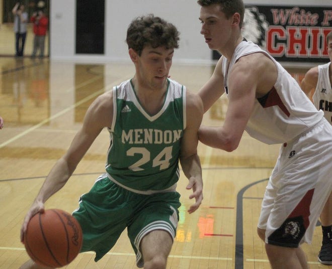 Mendon's Lukas Crotser drives the baseline around the defense of Noah Krull of White Pigeon Tuesday.