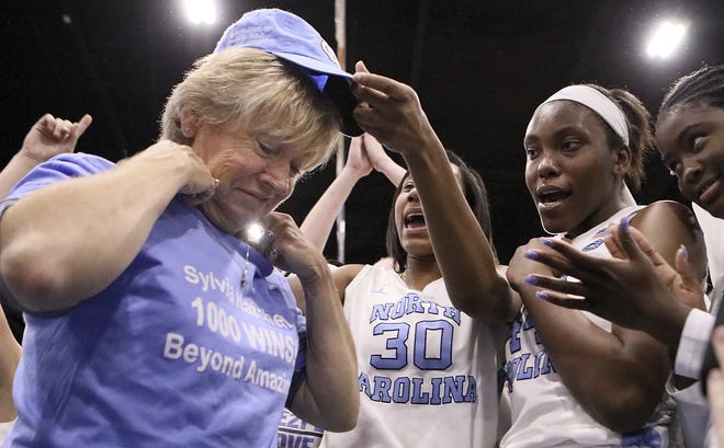 North Carolina coach Sylvia Hatchell is greeted by her players after their 79-63 win over Grambling State in an NCAA college basketball game in the Crescom Bank Holiday Invitational tournament, Tuesday, Dec. 19, 2017, at the Myrtle Beach Convention Center in Myrtle Beach, S.C. Hatchell, who battled leukemia and was declared cancer-free in 2014, earned her 1,00th career coaching victory with the win. (Janet Blackmon Morgan/The Sun News via AP)