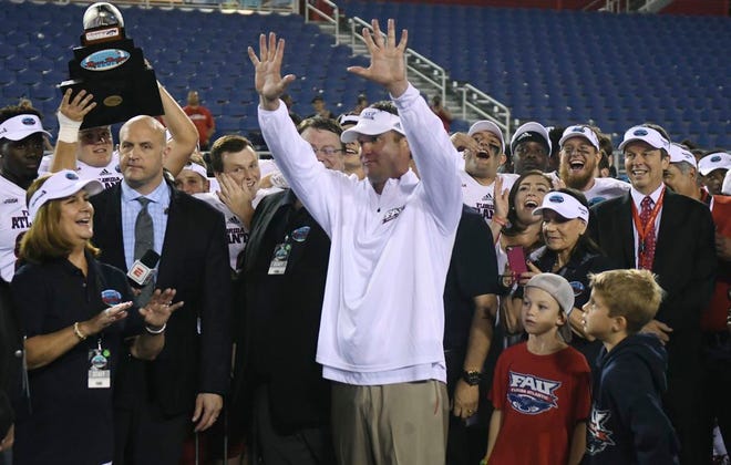 Florida Atlantic head coach Lane Kiffin holds up 10 fingers as fans shout "ten more years" following a 50-3 victory over Akron in an NCAA college football game in Boca Raton, Fla., Tuesday, Dec. 19, 2017. (Jim Rassol/South Florida Sun-Sentinel via AP)