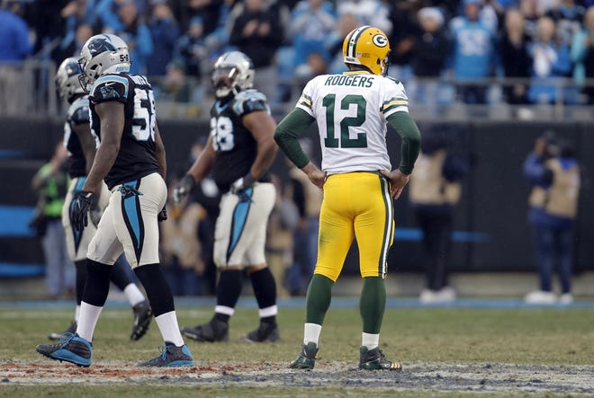 Green Bay Packers' Aaron Rodgers (12) watches as Carolina Panthers players walk off the field after a Green Bay Packers fumble late during the second half of an NFL football game in Charlotte, N.C., Sunday, Dec. 17, 2017. [AP Photo/Bob Leverone]