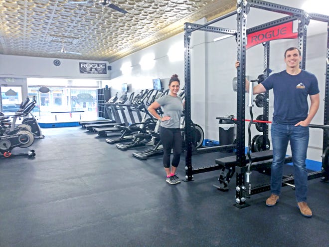 Nikki Bowman, manager, and Dr. Dakota Zickefoose, owner-founder, pose with newly installed exercise and training equipment at Strive Health Fitness, 246 W. Main St., Loudonville.