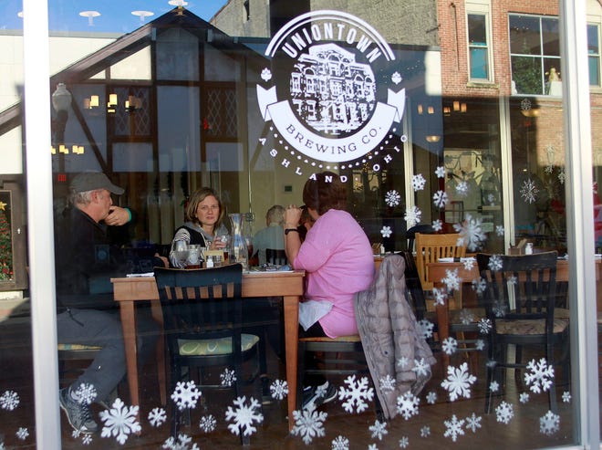 Pat Montgomery, Stacy Bauer and Glenda Montgomery sit at the table in the front window of the Uniontown Brewing Company shortly after it opened at 11am Wednesday, Dec. 20, 2017 in time for lunch at the new downtown establishment in the old Gilbert's Furniture Store. Tom E. Puskar, Times-Gazette.com