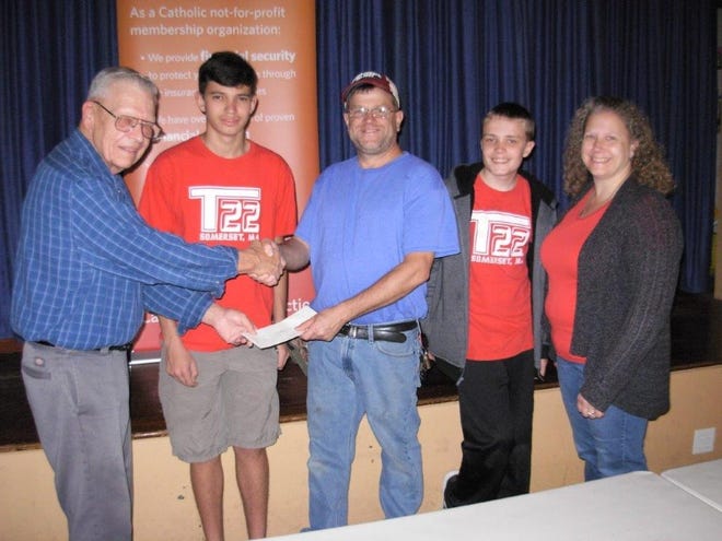 Chapter President Al Dumoulin, left, is happy to present the proceeds raised to, from left, Drew Borden, Scout Master Brian McLintock, Jared McLintock and Diana Urick. [Submitted Photo]