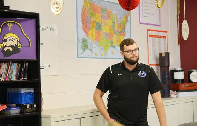 Cameron Gupton, American History teacher at Greene Early College High School stands inside his classroom Wednesday. Gupton won Southeast Region Teacher of the Year. [Janet S. Carter / The Free Press]