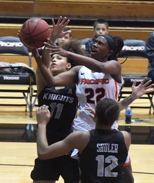 Pacific's Desire Finnie scores past Central Florida's Kayla Thigpen during the first half on Wednesday in the Spanos Center.

[CALIXTRO ROMIAS/THE RECORD]