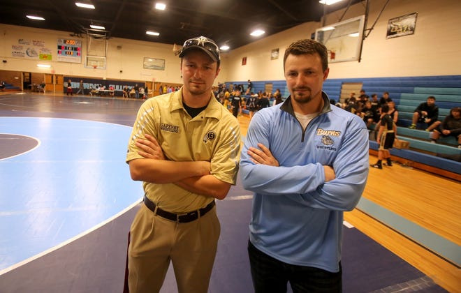 Twin brothers Dan Grellman, left, of Gaffney, and Johnathon Grellman, for Burns, had their teams meet on the mats for the first time Wednesday night at the Burns High Gym. [Brittany Randolph/The Star]