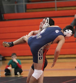 Kenny Garcia of Sturgis takes down his opponent from Otsego on Wednesday.