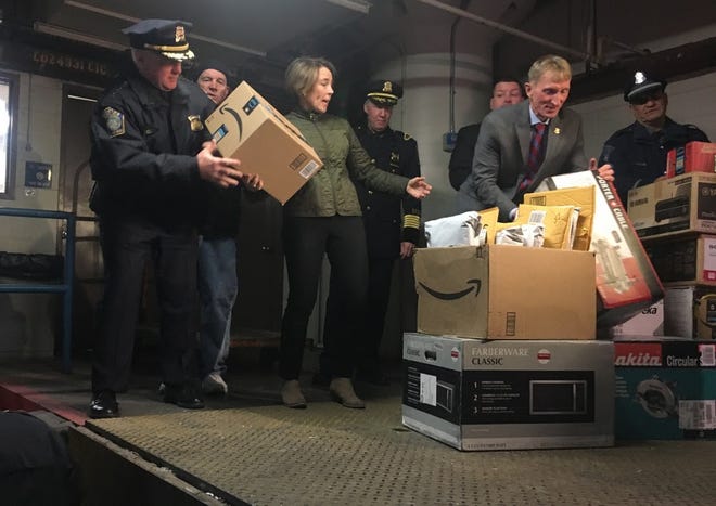 "Dozens and dozens" of unopened Amazon packages were recovered in the investigation into a series of restaurant break-ins in Eastern Massachusetts, said Attorney General Maura Healey, who joined Boston Police Commissioner William Evans Wednesday to load the parcels into a van for return to Amazon. [Photo: Katie Lannan/SHNS]