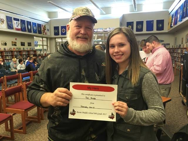 Kennedy Lewis, right, presents her grandpa and hero Ron George with a certificate. Photo by Gena Johnson/News-Republican