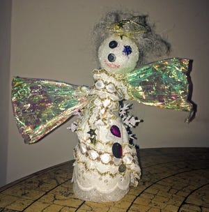 The handmade angel topping our Christmas tree might be kind of ugly and falling apart, but it's also become an invaluable part of the family's Yuletide traditions. [MONICA LEWIS/CONTRIBUTED PHOTO]