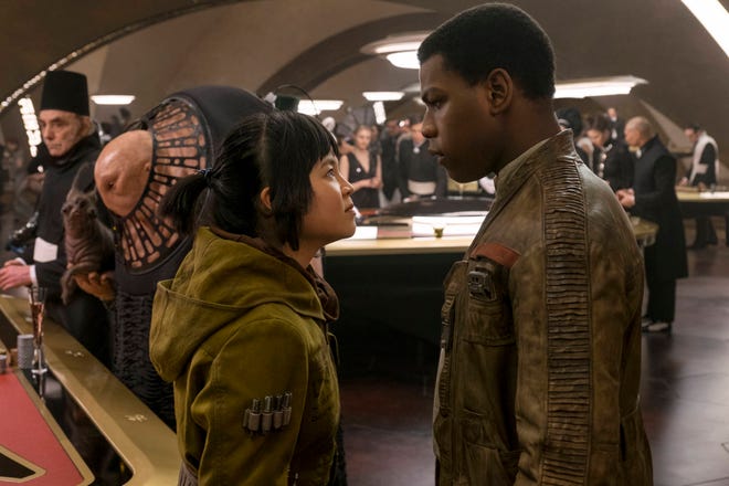 This image released by Lucasfilm shows Kelly Marie Tran, left, and John Boyega in “Star Wars: The Last Jedi.” (David James/Lucasfilm via AP)