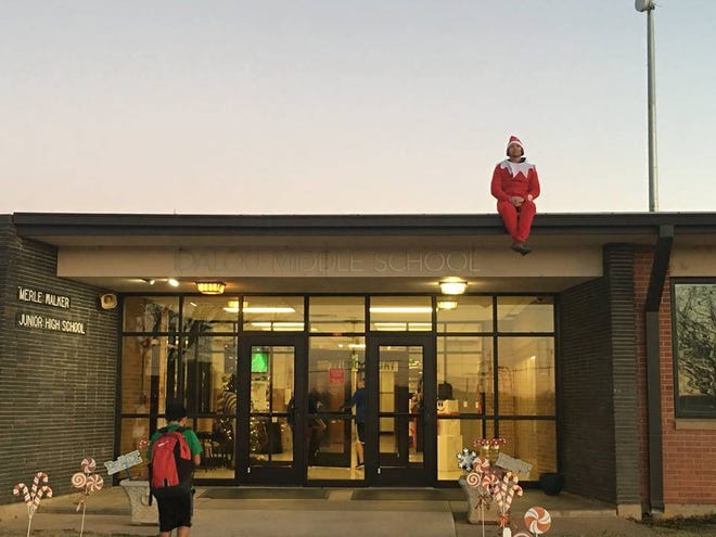 Idalou Middle School Principal Josh Damron — also known as the elf on the shelf — sits on the roof of the school on Wednesday morning as students arrive for school. (Idalou ISD Facebook)
