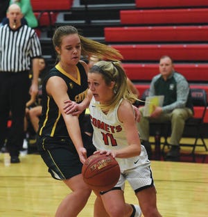 North Polk’s Katie Scott dribbles by Saydel’s Katie Schmidt as she nears the basket during the first half of the No. 12 Comets’ 62-27 win over the Eagles Dec. 12 at Alleman.