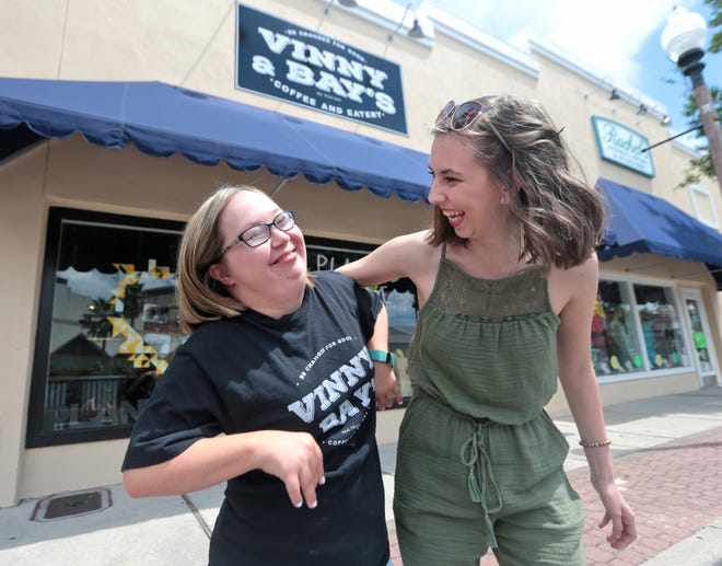 Baylee Hanson giggles with Madeline Lovejoy outside of Vinny & Bay's on Harrison Avenue in Panama City. [PATTI BLAKE/THE NEWS HERALD]