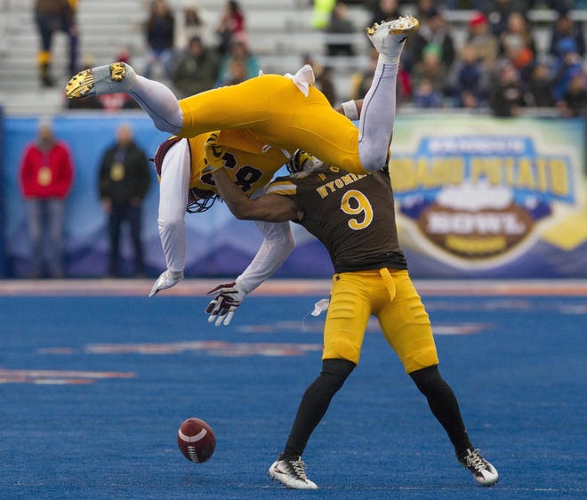 Wyoming cornerback Tyler Hall (9) upends Central Michigan tight end Tyler Conklin (83), breaking up a pass during the first half of the Famous Idaho Potato Bowl NCAA college football game Friday, Dec. 22, 2017, in Boise, Idaho. (Darin Oswald/Idaho Statesman via AP)