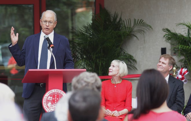 Jim France speaks duirng the dedication of the Sharon and Jim France Admissions Center at Florida Southern Colledge on Thursday while college President Anne Kerr and architect Jeffrey Baker look on. [ CALVIN KNIGHT/FLORIDA SOUTHERN COLLEGE ]