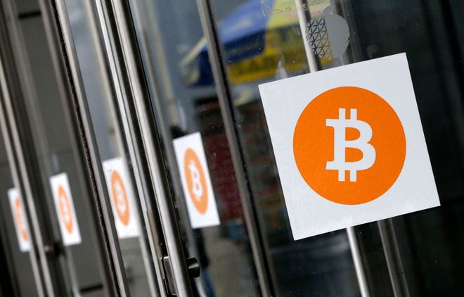 Bitcoin logos at the Inside Bitcoins conference and trade show in New York in 2014. A bitcoin sell-off that began at the beginning of the week is gaining momentum. [ASSOCIATED PRESS ARCHIVE]