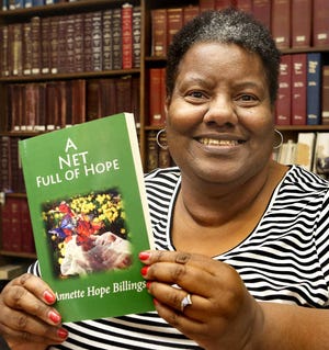 Topekan Annette Hope Billings, shown here with a book of poetry she wrote that was published in 2015, penned a poem that Kansas Attorney General Derek Schmidt’s office shared this month at four receptions held around the state in remembrance of crime victims who lost their lives. (2015 file photo/The Capital-Journal)