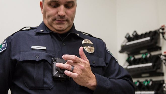 Brent Dupre, intelligence and technology commander for the Austin Police Department, demonstrates body cameras at the eastern substation Oct. 13. QILING WANG / AMERICAN-STATESMAN