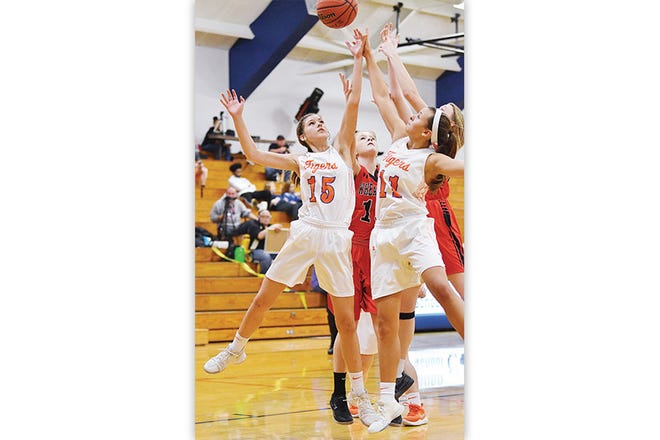 Randleman's Emma Marlow, left, and Kaylee Sexton battle Wheatmore's Ashlyn Linville for a rebound in a game that went to the wire.
