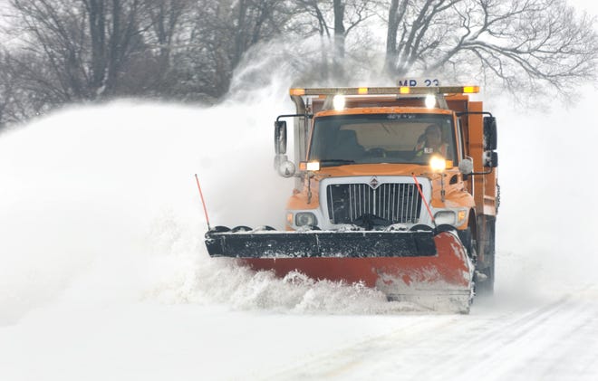 MATT DAYHOFF/JOURNAL STAR A plow crashes through snow piled up on westbound Eureka Road in Woodford County in a file photo from 2014.