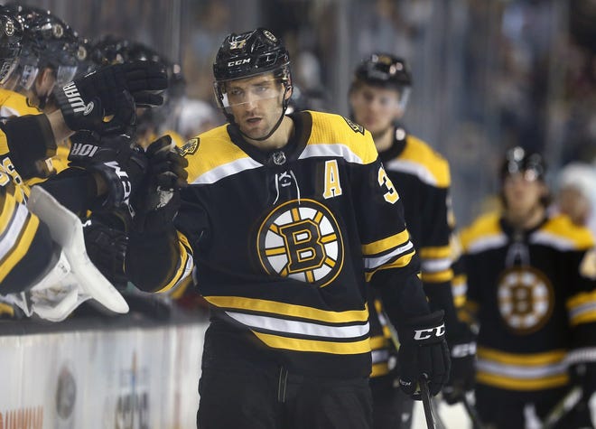 Bruins forward Patrice Bergeron (middle) celebrates a goal during the third period of Boston's 3-1 win over the Detroit Red Wings at the TD Garden on Saturday. [AP Photo/Michael Dwyer]