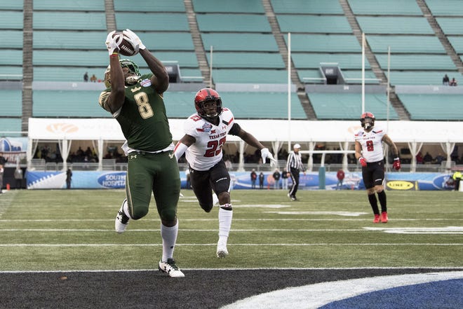 South Florida wide receiver Tyre McCants (8) catches a touchdown pass with 16 seconds left in the fourth quarter, putting South Florida up on Texas Tech 37-34 during the Birmingham Bowl NCAA college football game on Saturday, Dec. 23, 2017, in Birmingham. [AP Photo/Albert Cesare]