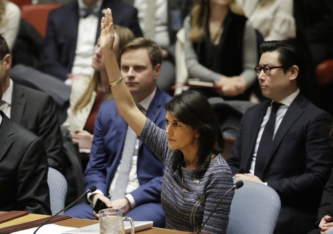 U.S. Ambassador Nikki Haley votes in favor of a resolution on Dec. 22, at United Nations headquarters. The Security Council is voting on proposed new sanctions against North Korea, including sharply lower limits on its refined oil imports, the return home of all North Koreans working overseas within 12 months, and a crackdown on the country's shipping. [MARK LENNIHAN / ASSOCIATED PRESS]