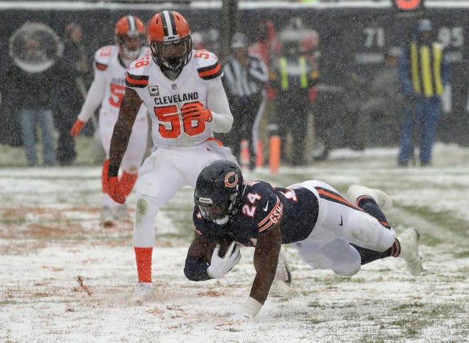 Chicago Bears running back Jordan Howard (24) dives into the end zone for a rushing touchdown as Cleveland Browns outside linebacker Christian Kirksey (58) watches in the first half of an NFL football game in Chicago, Sunday, Dec. 24, 2017. (AP Photo/Charles Rex Arbogast)
