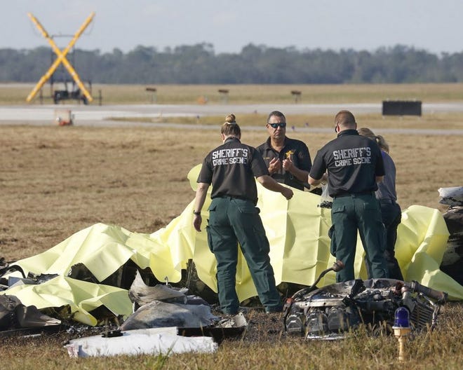 Polk County Sheriff's deputies investigate the scene of a fatal plane crash Sunday morning. The twin-engine Cessna 340 crashed shortly after take-off this morning at Bartow Municipal Airport, killing the pilot, local attorney John Hugh Shannon, and four others, authorities said.