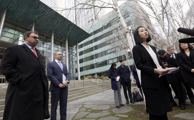 In this Thursday, Dec. 21, 2017 file photo, Mariko Hirose, right, a litigation director at the Urban Justice Center, speaks to reporters accompanied by Mark Hetfield, president & CEO of HIAS, left, and Rabbi Will Berkowitz, Jewish Family Service of Seattle CEO, in front of a federal courthouse in Seattle. On Saturday, Dec. 23, 2017, U.S. District Judge James Robart partially lifted a Trump administration ban on certain refugees after the American Civil Liberties Union and Jewish Family Service argued that the policy prevented people from some mostly Muslim countries from reuniting with family living legally in the United States. (AP Photo/Elaine Thompson)